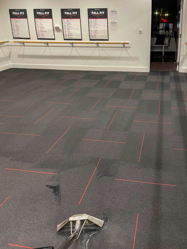 Photo of a commercial gym floors being hot steamed cleaned