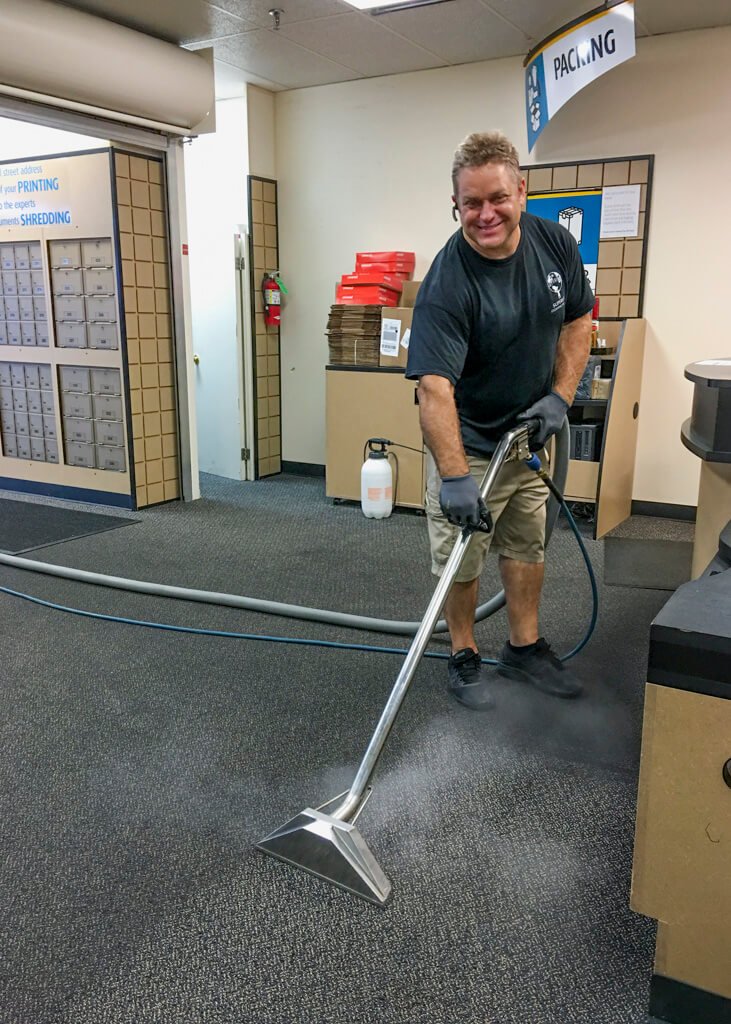 Photo of the owner, Greg steam cleaning The UPS Store floor