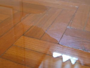 Photo of a tiled wood floor with flood water on it